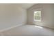 Bedroom featuring plush carpeting, neutral paint, and natural light from the window at 141 Compass Rd, Hampton, GA 30228