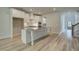 Modern kitchen featuring white cabinets, an island, and stainless steel appliances, perfect for cooking and entertaining at 141 Compass Rd, Hampton, GA 30228