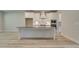 Modern kitchen featuring a center island with seating and white cabinets at 141 Compass Rd, Hampton, GA 30228