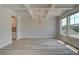 Open living area with coffered ceilings, large windows, and plank flooring at 141 Compass Rd, Hampton, GA 30228