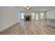 Large open living room featuring a brick fireplace, plank floors, and ceiling fan at 141 Compass Rd, Hampton, GA 30228