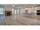 Spacious living space connects the kitchen and fireplace, offering a warm and inviting area for gatherings at 141 Compass Rd, Hampton, GA 30228