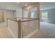 Bright upstairs hallway featuring neutral paint, white banisters, and access to multiple rooms at 141 Compass Rd, Hampton, GA 30228