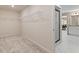 Neutral walk-in closet with wall shelving and a view into the main bathroom and bedroom at 141 Compass Rd, Hampton, GA 30228