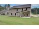 View of the backyard with a covered patio area extending from the home at 145 Compass Rd, Hampton, GA 30228