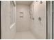 Modern shower with sleek fixtures, marble-look tile, and a glass door at 145 Compass Rd, Hampton, GA 30228