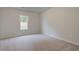 Cozy bedroom featuring plush carpeting, a large window, and neutral wall color at 145 Compass Rd, Hampton, GA 30228