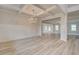 Elegant dining room showcasing a decorative chandelier, wainscoting, and light wood floors at 145 Compass Rd, Hampton, GA 30228