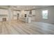 Modern kitchen with white cabinetry, an island, stainless steel appliances, and wood floors at 145 Compass Rd, Hampton, GA 30228