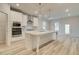 Well-lit kitchen with a large island, stainless appliances, and access to the backyard at 145 Compass Rd, Hampton, GA 30228