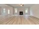 Spacious living room with wood floors, a fireplace, and several windows for ample natural light at 145 Compass Rd, Hampton, GA 30228