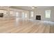 Bright living room with light wood floors, a fireplace, and an open view to the kitchen at 145 Compass Rd, Hampton, GA 30228