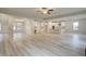 Expansive living space blending the kitchen, dining, and living areas with light wood flooring at 145 Compass Rd, Hampton, GA 30228