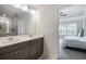 Modern bathroom featuring double sinks, gray cabinets, and a glass-enclosed shower at 319 Hayden Cir, Woodstock, GA 30189