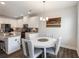 Bright dining area with modern chandelier, next to the kitchen featuring granite countertops at 319 Hayden Cir, Woodstock, GA 30189