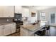 Modern kitchen featuring granite counters, stainless appliances, an island with seating and an adjacent dining area at 319 Hayden Cir, Woodstock, GA 30189