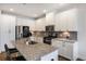 Bright kitchen with granite countertops, stainless steel appliances, island seating, and ample cabinet space at 319 Hayden Cir, Woodstock, GA 30189