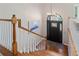 Elegant foyer with hardwood stairs, modern chandelier, and decorative front door at 3850 Pilgrim Mill Rd, Cumming, GA 30041