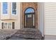 Elegant front entrance with a dark wood door, decorative glass, and stone steps at 3850 Pilgrim Mill Rd, Cumming, GA 30041