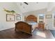 Sun-drenched main bedroom showcases vaulted ceilings, hardwood floors, and unique decorative fish at 3850 Pilgrim Mill Rd, Cumming, GA 30041