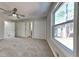 Spacious bedroom featuring a ceiling fan, carpet flooring, three large closets, and a large window at 1083 Stoney Creek Ln, Austell, GA 30168