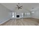Spacious living room with modern flooring, a fireplace, ceiling fan, and expansive windows at 1083 Stoney Creek Ln, Austell, GA 30168