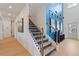 Bright hallway features hardwood floors, staircase, and a blue accent wall with modern decor at 137 Compass Rd, Hampton, GA 30228