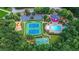 Aerial view of tennis courts, basketball court, playground and pool amidst lush trees at 325 Stonecastle Pass, South Fulton, GA 30331