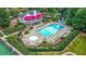 Aerial view of community pool, hot tub, lounge chairs, and clubhouse with gardens at 325 Stonecastle Pass, South Fulton, GA 30331