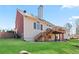 Exterior of the home with a walkout to the backyard, featuring a large deck and a well-manicured lawn at 325 Stonecastle Pass, South Fulton, GA 30331