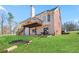 Exterior of the home with a walkout to the backyard, featuring a large deck and a well-manicured lawn at 325 Stonecastle Pass, South Fulton, GA 30331