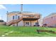 Spacious backyard view featuring a large deck, lush green lawn, and direct access from the house at 325 Stonecastle Pass, South Fulton, GA 30331