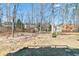 Backyard view showcasing a wooded area, providing a private outdoor space at 325 Stonecastle Pass, South Fulton, GA 30331