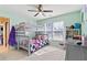 Bedroom with light green walls and carpet with a bunkbed and white trim at 325 Stonecastle Pass, South Fulton, GA 30331