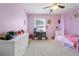 Bedroom featuring pink walls and carpet with a draped canopy over the bed at 325 Stonecastle Pass, South Fulton, GA 30331