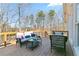 Outdoor deck with seating area overlooking a wooded backyard, perfect for entertaining and relaxation at 325 Stonecastle Pass, South Fulton, GA 30331