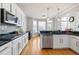 Kitchen with white cabinets, stainless steel appliances, and granite countertops at 325 Stonecastle Pass, South Fulton, GA 30331