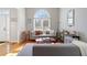 Spacious living room featuring hardwood floors, gray couches, and a bright arched window at 325 Stonecastle Pass, South Fulton, GA 30331