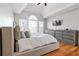 A bright main bedroom with hardwood floors, a large window, and an angled ceiling at 325 Stonecastle Pass, South Fulton, GA 30331