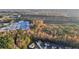 An aerial view of the neighborhood showcasing the surrounding wooded landscape with fall foliage at 382 Daffodil Dr, Temple, GA 30179