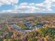An aerial view of suburban neighborhood with trees and foliage with fall colors at 382 Daffodil Dr, Temple, GA 30179