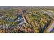 An aerial view of a suburban neighborhood surrounded by trees and foliage in full fall color at 382 Daffodil Dr, Temple, GA 30179