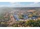 Aerial view of a sprawling neighborhood surrounded by lush greenery and mature trees at 382 Daffodil Dr, Temple, GA 30179