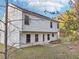 Backyard of a two-story home with a small patio, ample outdoor space, and lots of greenery at 382 Daffodil Dr, Temple, GA 30179