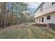 Spacious backyard featuring lush greenery, a firepit, exterior access and ample space for outdoor activities at 382 Daffodil Dr, Temple, GA 30179