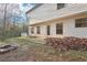 Backyard view featuring a concrete patio, a fire pit, and a detached storage shed at 382 Daffodil Dr, Temple, GA 30179