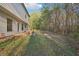 Backyard view showing a small concrete patio, a fire pit, and a wooded area at 382 Daffodil Dr, Temple, GA 30179