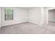 Bright bedroom featuring plush carpeting, natural light, and ensuite bathroom access at 382 Daffodil Dr, Temple, GA 30179