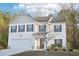 Charming two-story home with a two-car garage and beautifully manicured front yard at 382 Daffodil Dr, Temple, GA 30179
