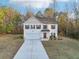 Charming two-story home with a two-car garage and beautifully manicured front yard at 382 Daffodil Dr, Temple, GA 30179